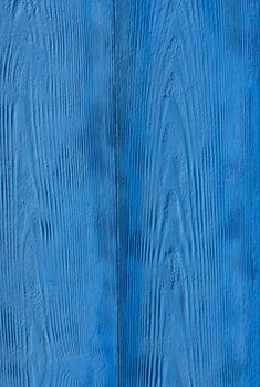 closeup of old wood with bright fresh blue paint