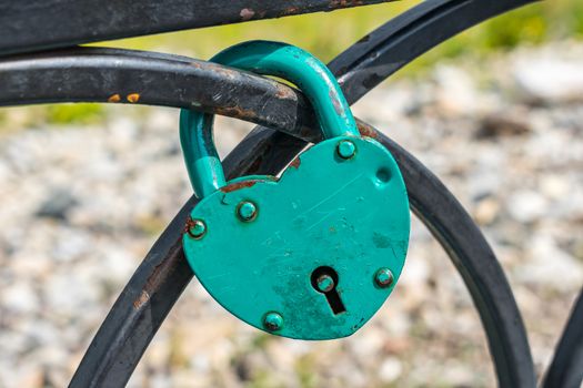 A padlock that is traditionally hung by the newlyweds on the railing of the bridge after the wedding