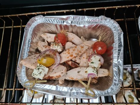 Grilled skewers with mixed vegetables served on a wooden cutting board with a vegan herb dip