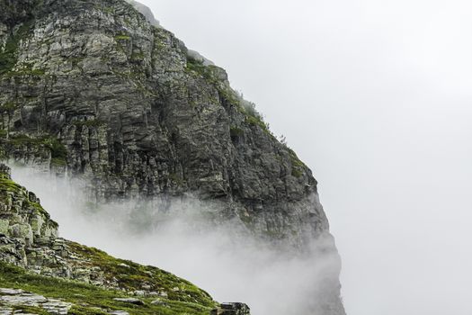 Fog, clouds, rocks and cliffs on Veslehødn Veslehorn mountain in Hemsedal, Norway.