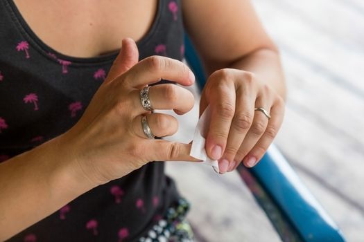 Removing varnish or degreasing nails. Preparation of nails for staining with varnish. Self manicure during self-isolation with coronovirus.