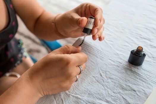 Staining nail gel polish. Self-manicure during self-isolation with coronovirus. The concept of personal care in all life circumstances. selective focus