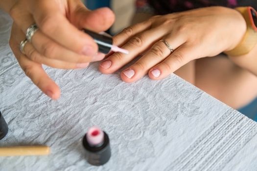 Staining nail gel polish. Self-manicure during self-isolation with coronovirus. The concept of personal care in all life circumstances, selective focus.