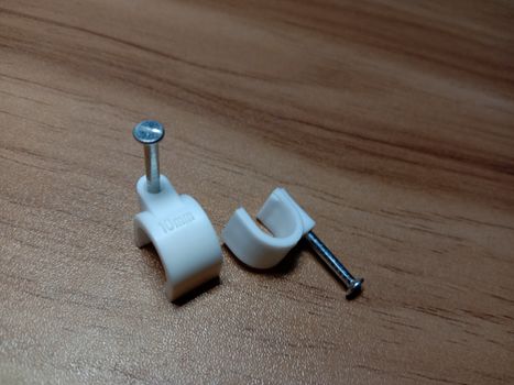 white colored wire pin on wooden table