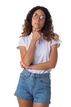 Portrait of young woman in glasses with curly hair thinking looking up isolated on white background