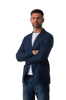 Portrait of handsome mid adult serious business man dresses in jeans and blue blazer posing with folded arms isolated on white background