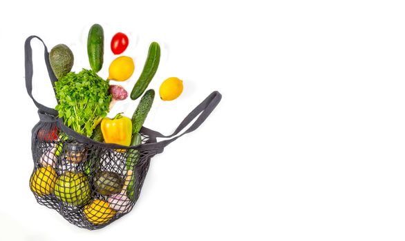 Shopping bag with assortment of fresh vegetables on white background