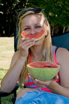 Funny young woman eating watermelon. Close-up.