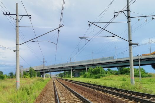 railway in a rural landscape. Evening, summer time, cloudy sky