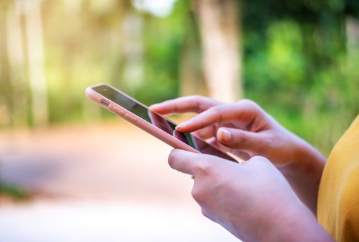 Social network and networking people concept, Hand women with smart phone mobile on blurred bokeh background,