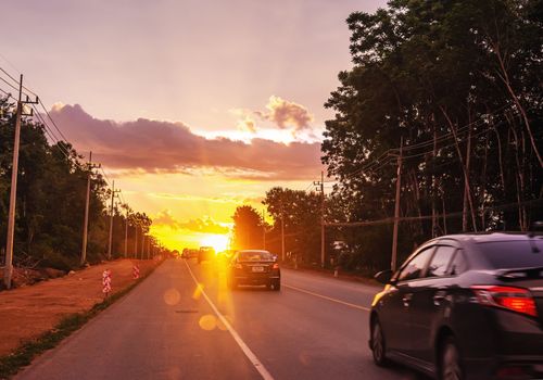 Pattalung, Thailand - August 29, 2020 : Car on road with colorful of sunset or sunrise in twilight