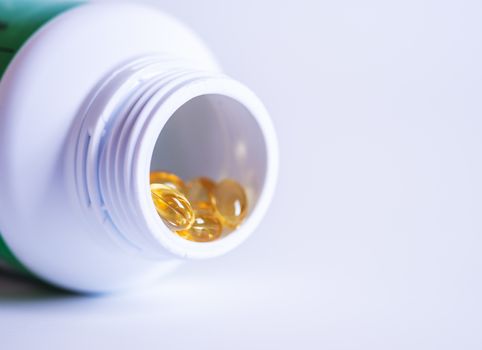 Pill spilling out of a bottle blurred background, Medicine capsule for health, Vitamin spilling out from bottle, Macro