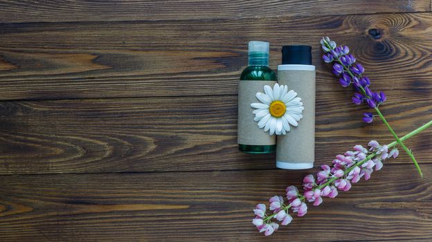 Cosmetic bottle containers with hermal camomile flowers Blank label for branding mock-up, Natural organic beauty product concept. Handmade, freshness.