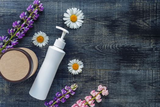 Cosmetic bottle containers with hermal camomile flowers Blank label for branding mock-up, Natural organic beauty product concept. Handmade, freshness.