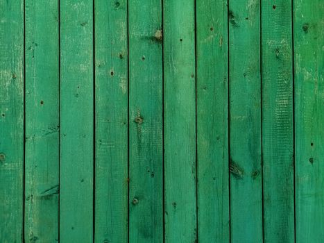 Green wood texture background. .Old ragged painted fence