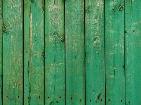 Green wood texture background. .Old ragged painted fence