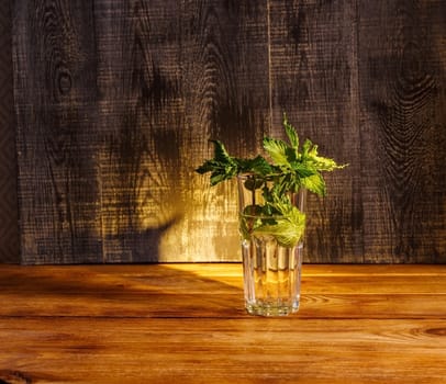 Bunch of fresh mint in a glass of water. Indoors, medicine.