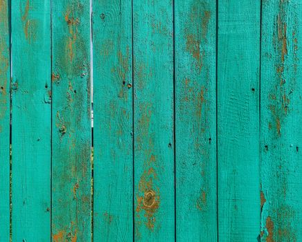 Green wood texture background. .Old ragged painted fence