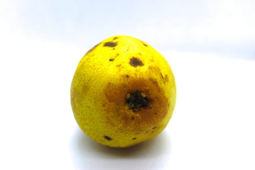 Beautiful yellow pear on white background. Yellow pear with black dots isolated on white background.