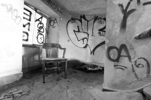 An Old Wooden Chair Inside an Abandoned Building Full of Debris and Dust