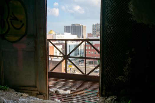 Looking Out an Open Door in an Old Abandoned Building at a City Skyline