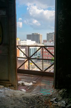 Looking Out an Open Door in an Old Abandoned Building at a City Skyline