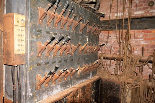 An Old Fashioned Switch Board Full of Rusty Levers With Black Handles on the Stage of an Abandoned Theatre