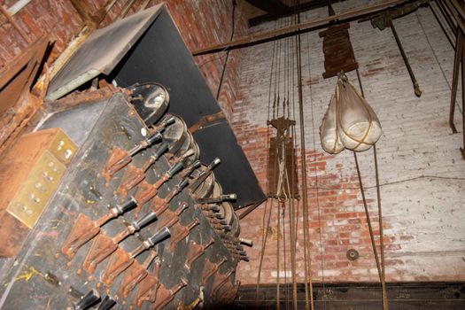 An Old Fashioned Switch Board Full of Rusty Levers With Black Handles on the Stage of an Abandoned Theatre