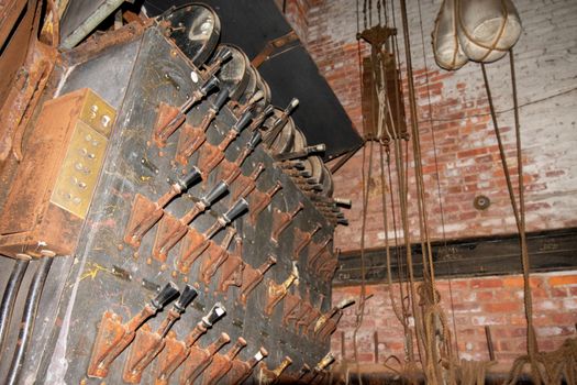 An Old Fashioned Switch Board Full of Rusty Levers With Black Handles on the Stage of an Abandoned Theatre