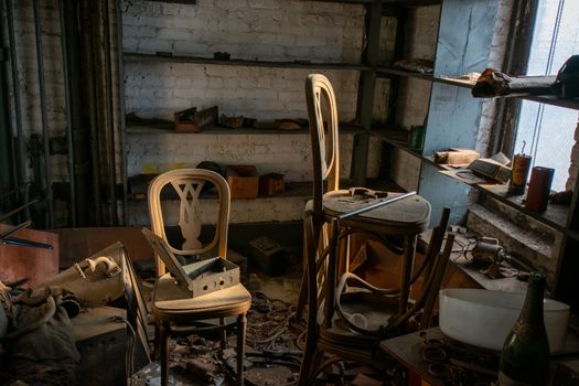 An Old Room in an Abandoned Building With Two Chairs Full of Debris and Trash