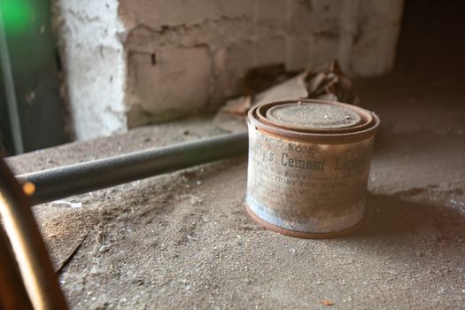 NEWARK, NEW JERSEY - JULY 17th, 2020: An Antique Can of Early's Cement Liquid Sits Forgotten in the Abandoned Proctor's Palace Theatre in Newark New Jersey.