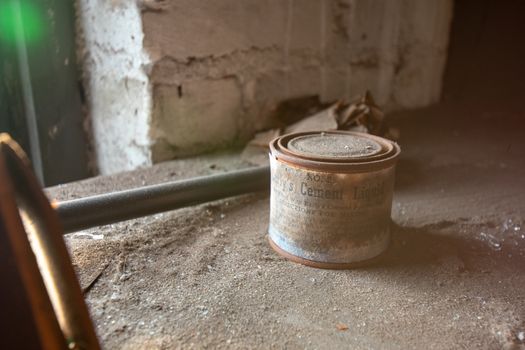 NEWARK, NEW JERSEY - JULY 17th, 2020: An Antique Can of Early's Cement Liquid Sits Forgotten in the Abandoned Proctor's Palace Theatre in Newark New Jersey.