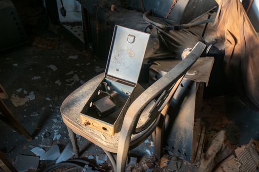 An Old Lockbox on an Antique Chair in an Abandoned Building Full of Debris