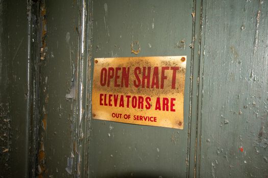 A Door to an Out of Service Elevator With an Open Shaft