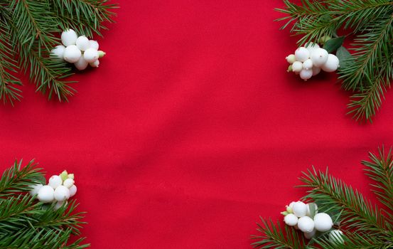 Christmas bouquet with fir branches, red bow and white dogwood berries on a white background . Christmas card. The theme of a winter holiday. Happy New Year.