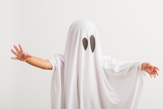 Funny Halloween Kid Concept, little cute child with white dressed costume halloween ghost scary, studio shot isolated on white background