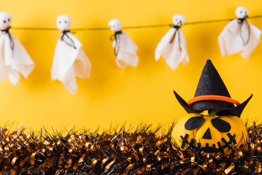 Funny Halloween day decoration party, Baby cute white ghost crafts scary face hanging and halloween pumpkin head jack lantern smile and spider on wooden, studio shot isolated, Happy holiday concept