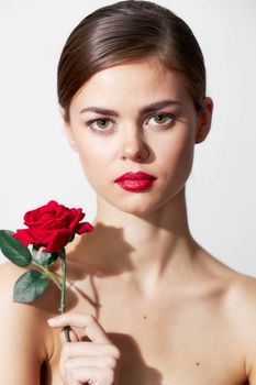 Woman with flower Bare shoulders are an attractive luxury look red lips cropped view
