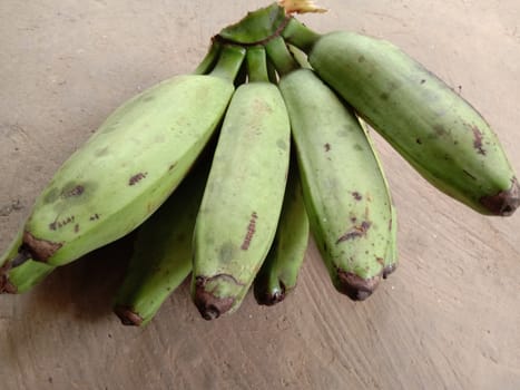 tasty and healthy raw banana bunch with blur background