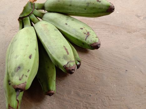 tasty and healthy raw banana bunch on floor