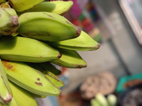 tasty and healthy raw banana bunch with blur background