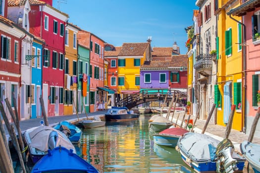 Colorful houses in downtown Burano, Venice, Italy with clear blue sky