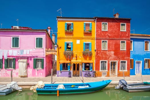 Colorful houses in downtown Burano, Venice, Italy with clear blue sky