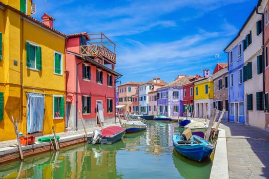 Colorful houses in downtown Burano, Venice, Italy with clear blue sky