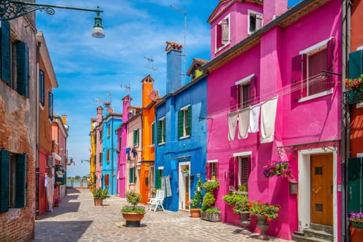 Colorful houses in downtown Burano, Venice, Italy with clear blue sky