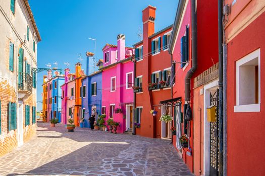 Colorful houses in downtown Burano, Venice, Italy with clear blue sky