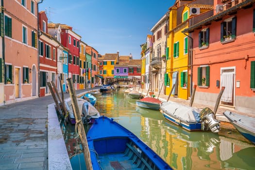 Colorful houses in downtown Burano, Venice, Italy with clear blue sky