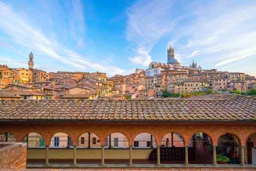 Downtown Siena skyline in Italy with morning blue sky