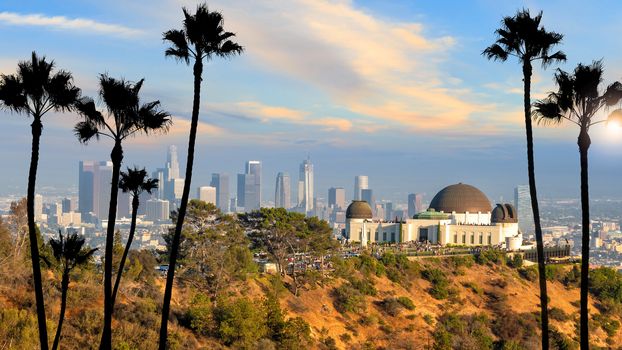 The Griffith Observatory and Los Angeles city skyline at sunset CA