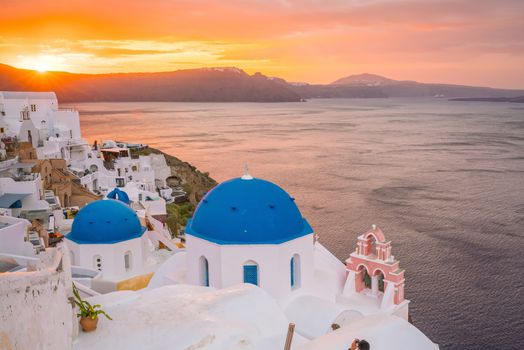 Oia town cityscape at Santorini island in Greece at sunset. Aegean sea